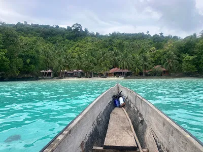 Postcard-perfect white sand beach with turquoise waters near Pulau Papan, Togian Islands, Indonesia