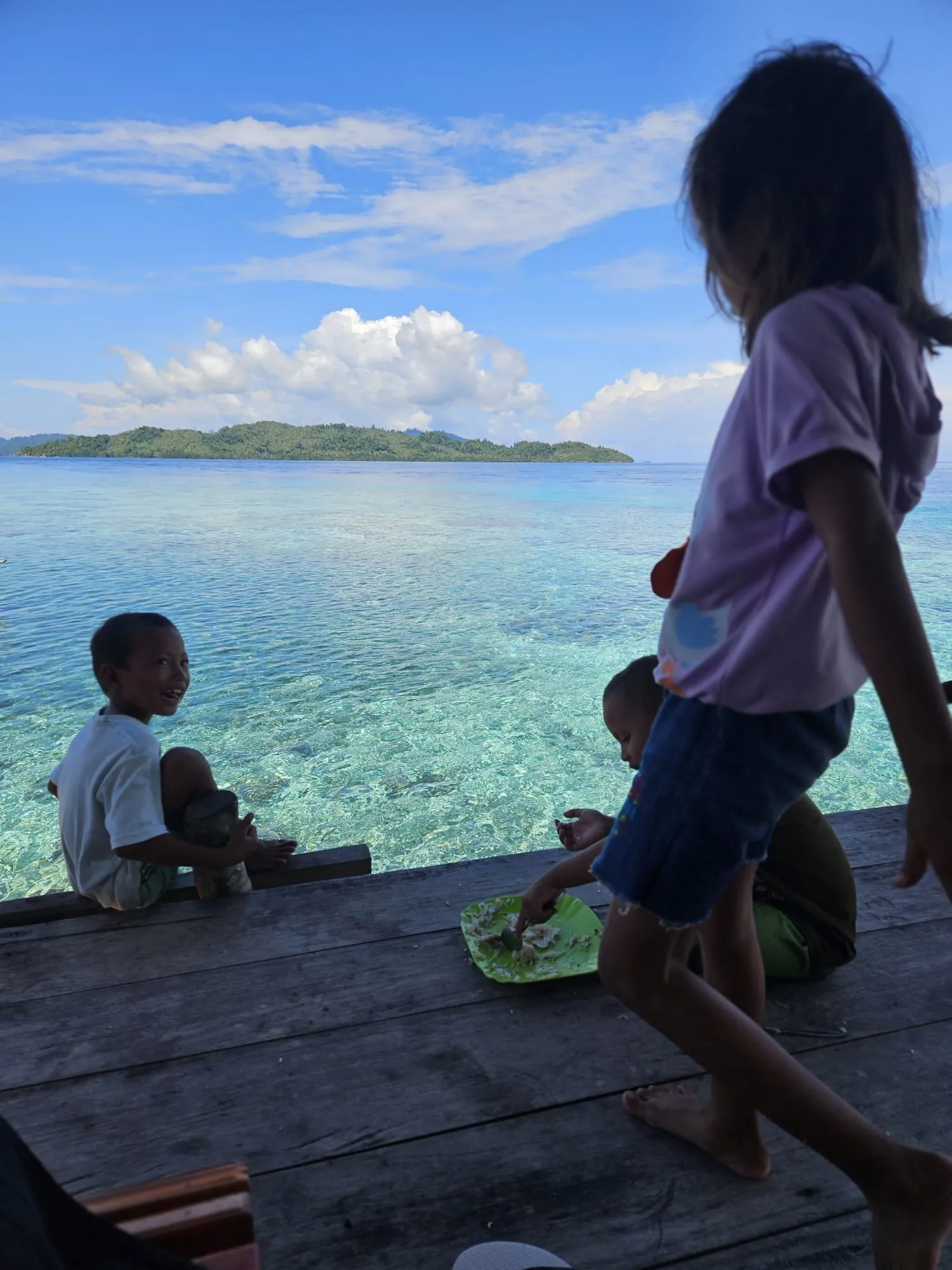 Family of Li An Homestay welcoming guests on Pulau Papan, Togian Islands, Sulawesi, Indonesia