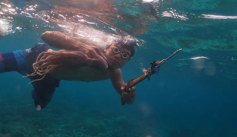 Traditional spearfishing techniques practiced by local fishermen in Togian Islands, Indonesia